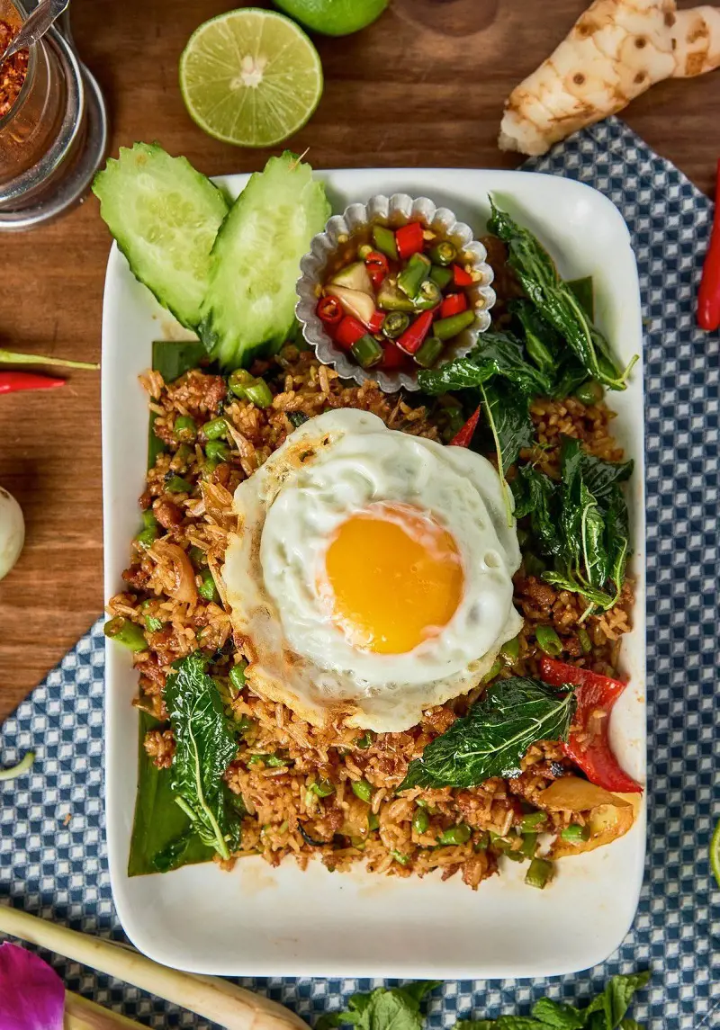 This popular Thai dish Khao Pad is a flavorful and tasty stir-fried rice dish that captures the essence of Thailand's culinary roots in every bite