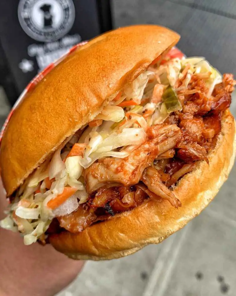 Pulled Chicken Sandwich made with hand-pulled fried chicken and topped with BBQ sauce and coleslaw