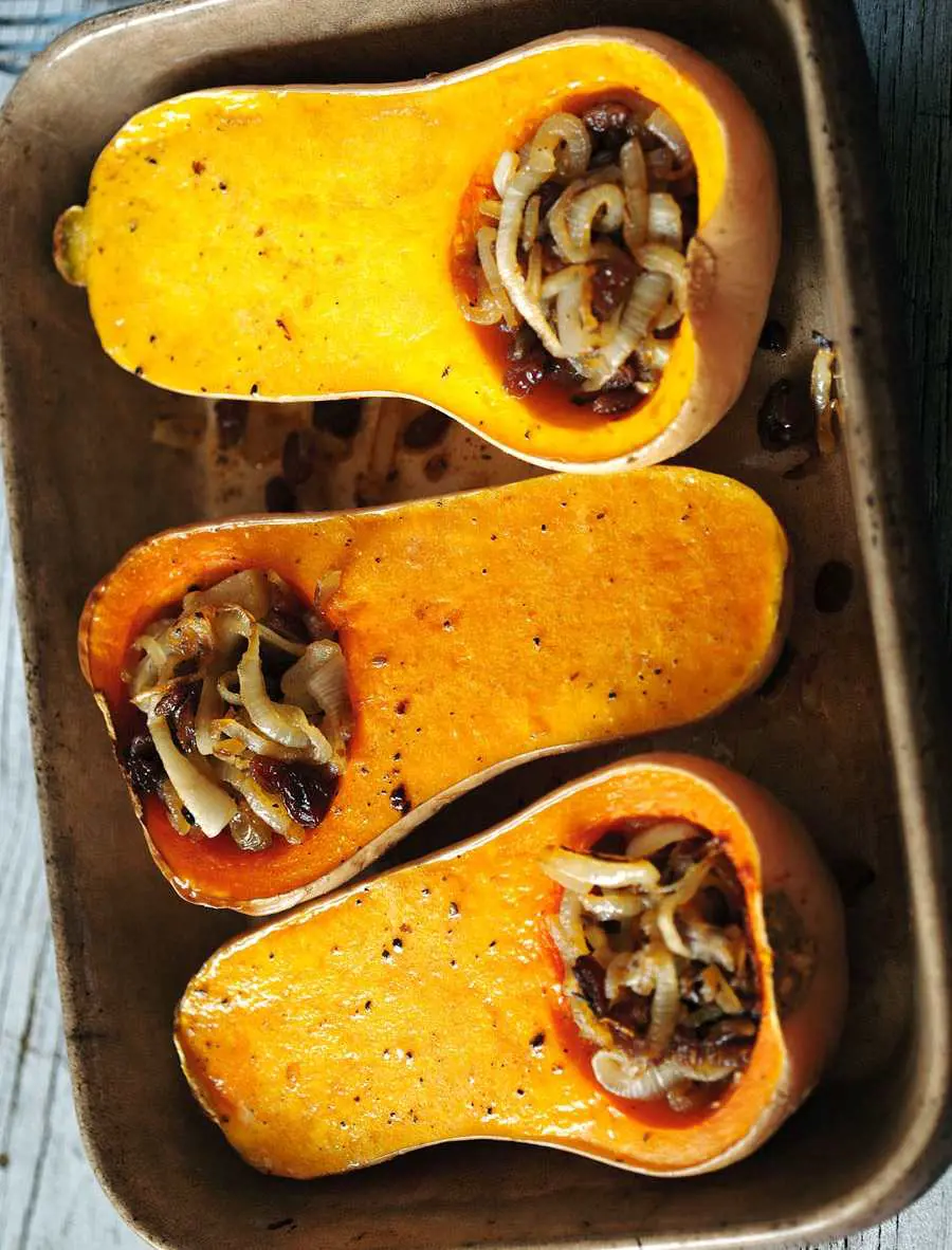 Roast butternut squash, adorned with spiced and caramelized onions, creates a delectable complement to grilled chicken or sausages